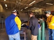 Michael Gall, Welding instructor with two students learning to weld.